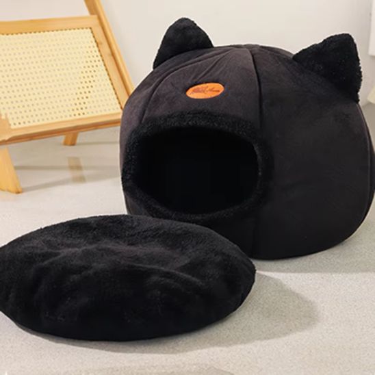 Niche pour chat noire avec coussin amovible en tissu doux, posée au sol