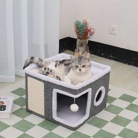 Niche cube grise à bordure blanche douce avec un chat allongé dessus.
