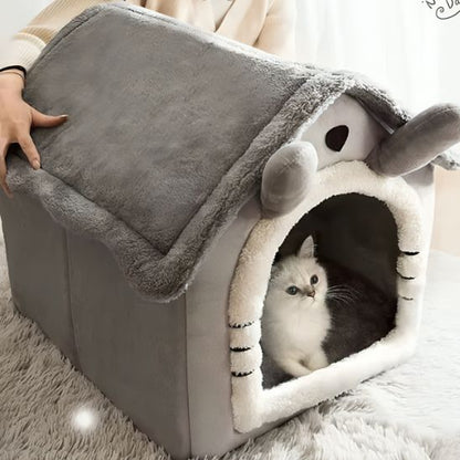 Chat blanc installé dans une grande niche FéliNiche sans fenêtre, toit ondulé et intérieur moelleux.